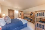 Lower level bedroom with queen bed and 2 sets of twin/twin bunks